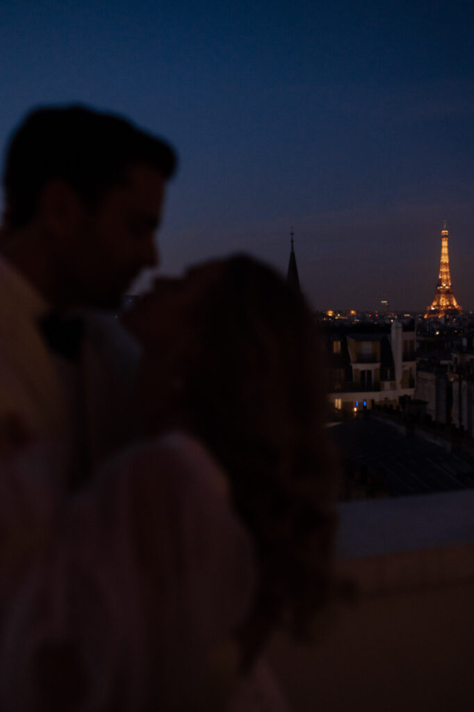 Couple having nighttime elopement session with the Eiffel Tower in the background. photographed by destination wedding photographer The Hazel Club