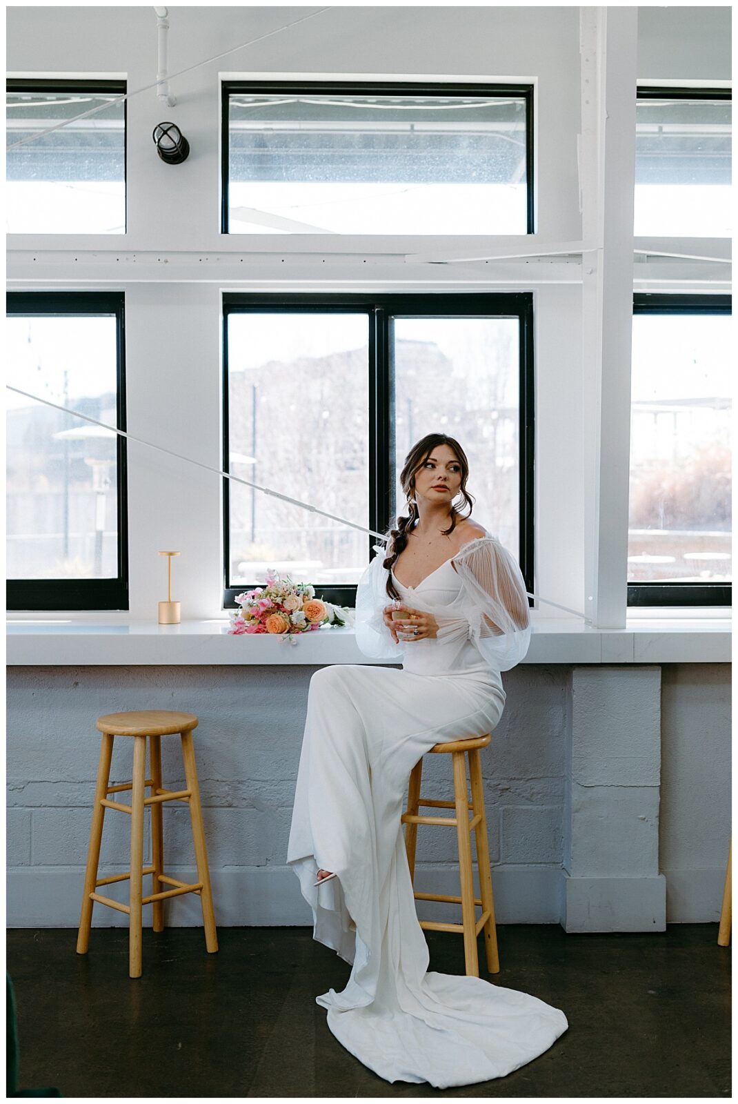 bride sits at bar at Junction West styled shoot