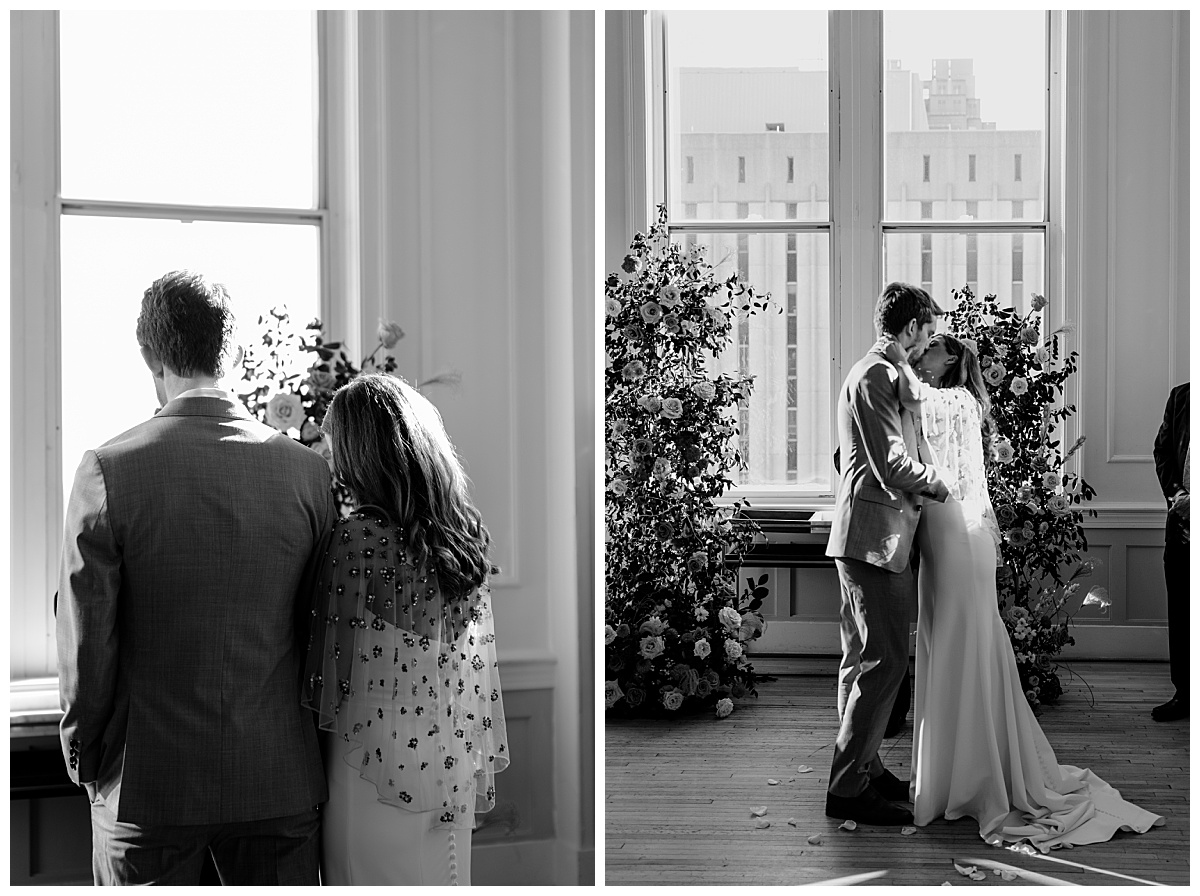 bride and groom kiss in front of ceremony arch by North Carolina wedding photographer