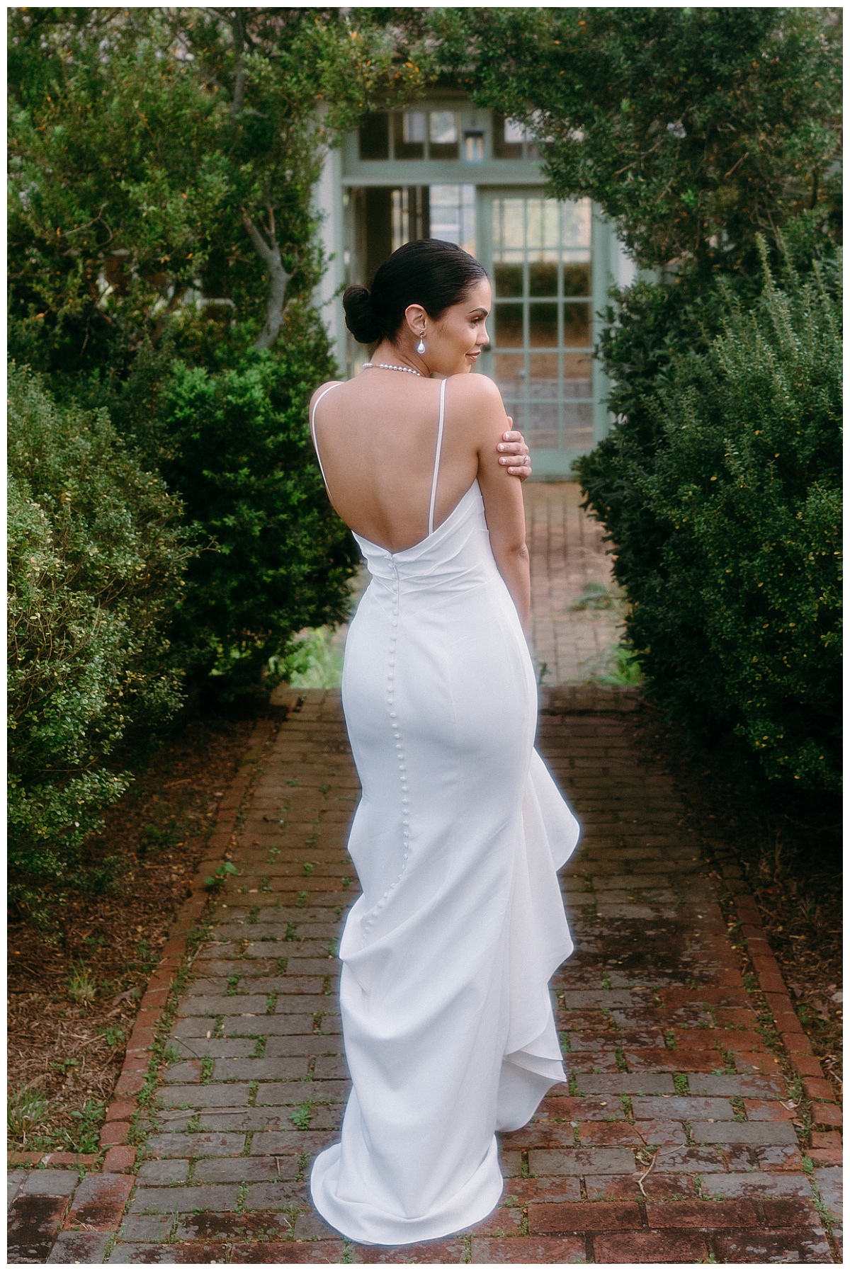 bride hugs herself and looks to the side by Charlotte wedding photographer