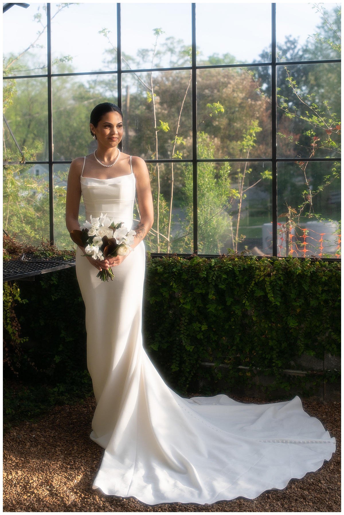 person holds bouquet in greenhouse by The Hazel Club