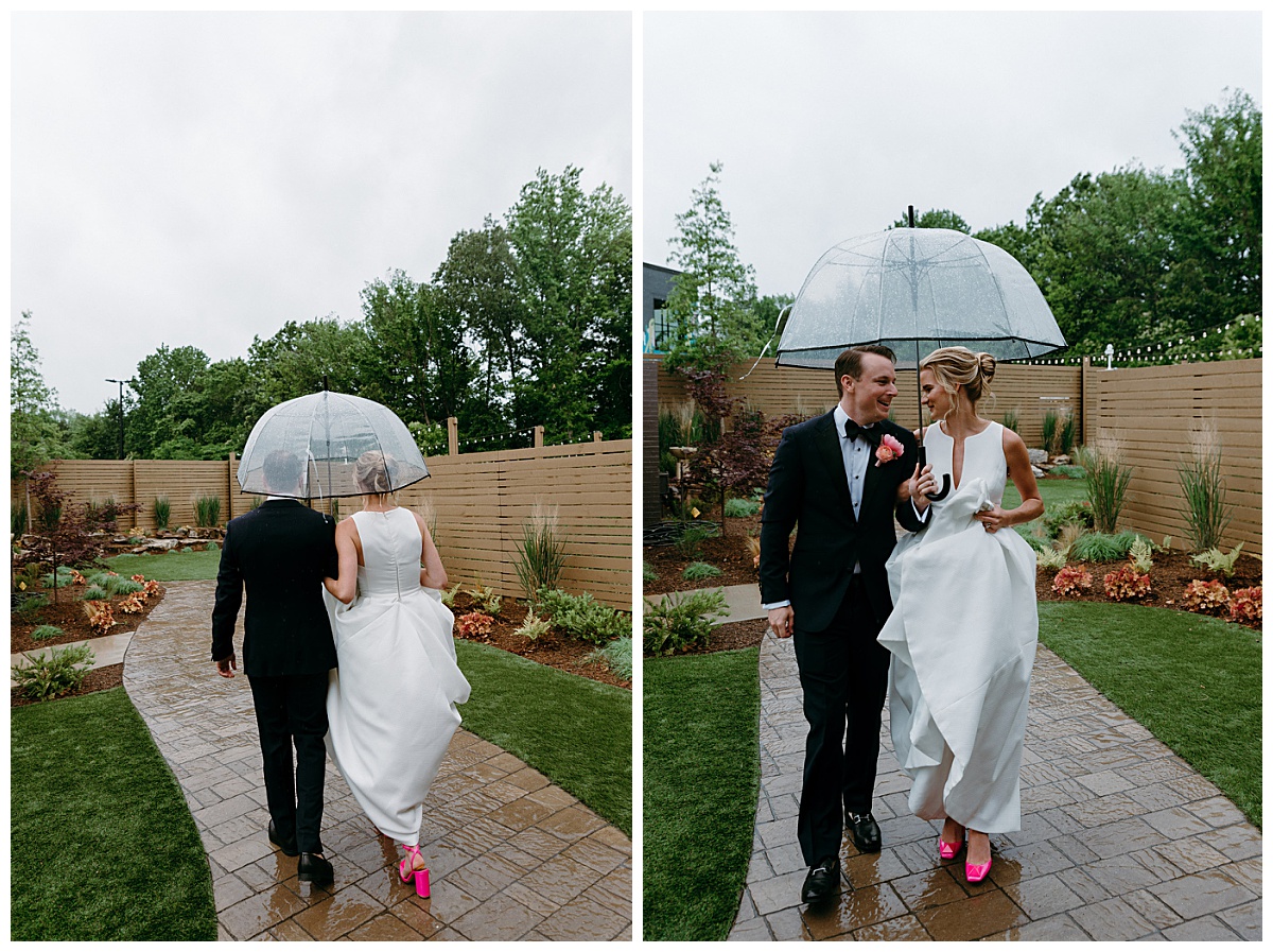couple walks outside together under clear umbrella by Charlotte wedding photographer